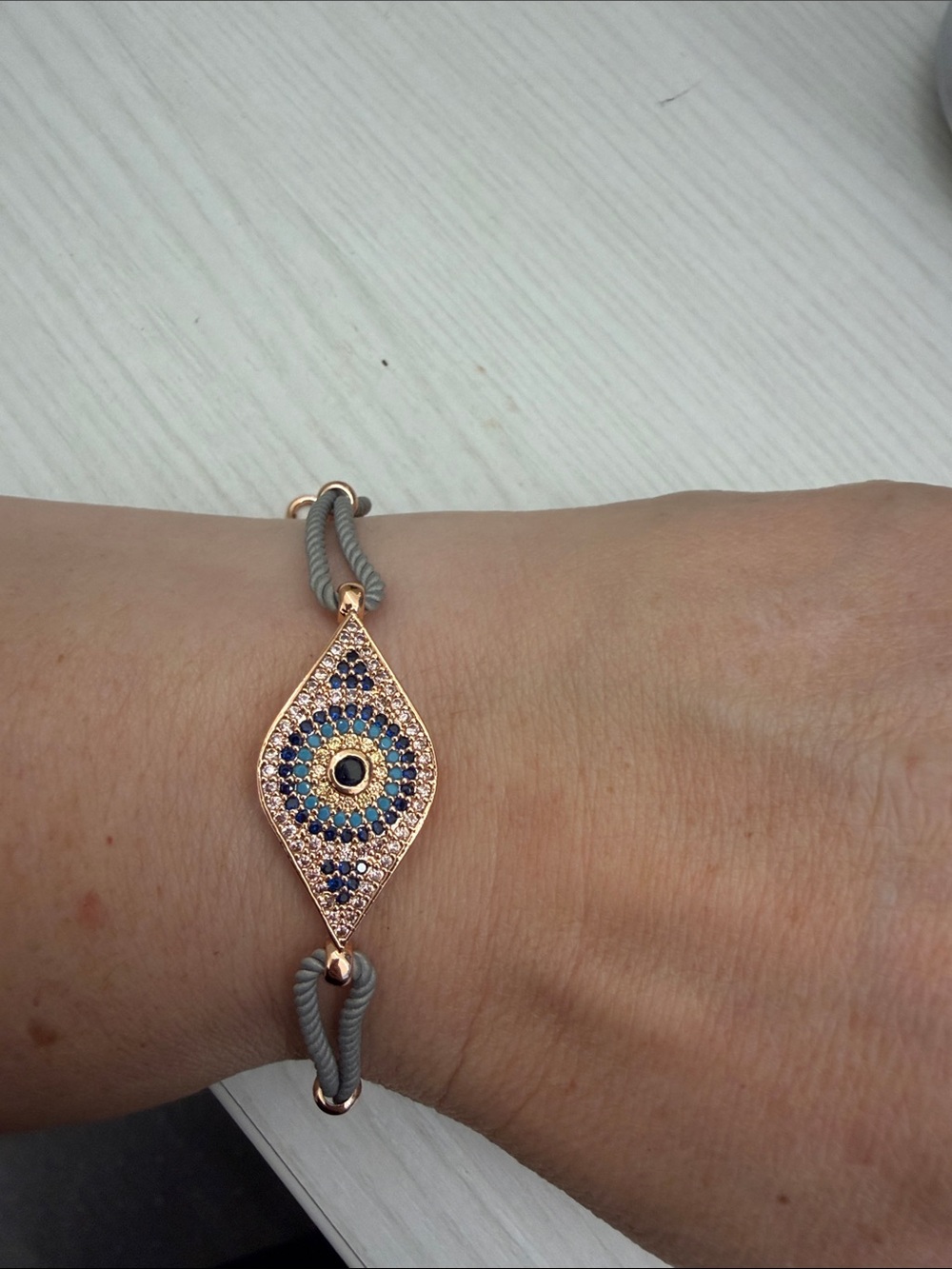 Rose Gold Evil Eye Bracelet with Blue Accents and Grey Cord